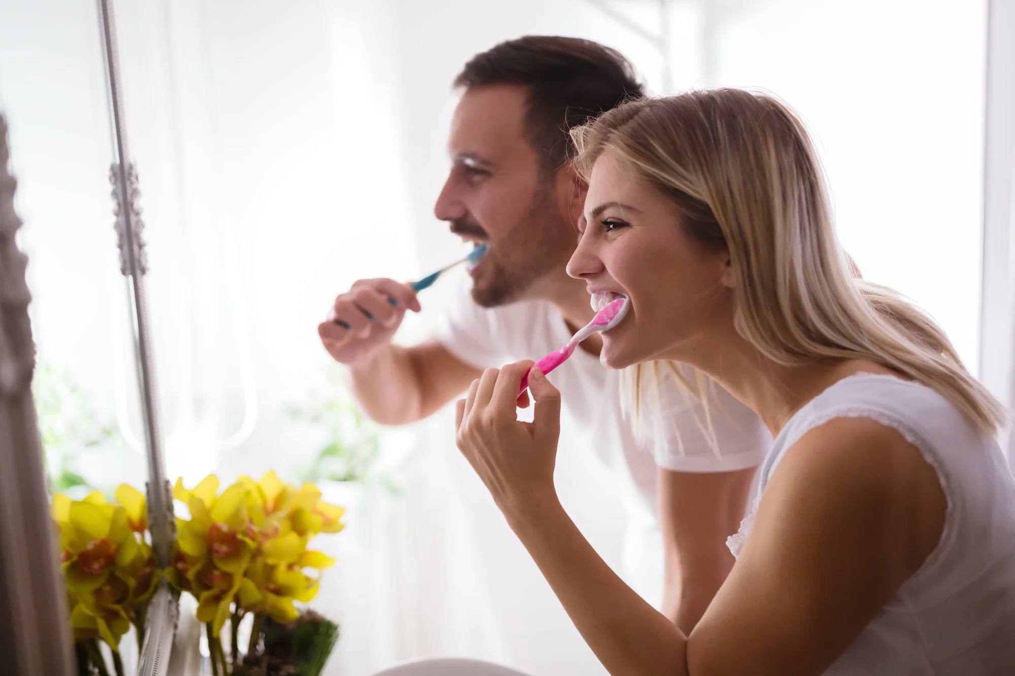 Couple washing teeth in morning